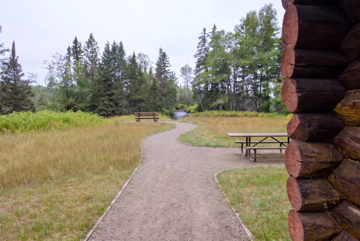 Concept illustration of a gravel path, picnic table and bench near the cabin