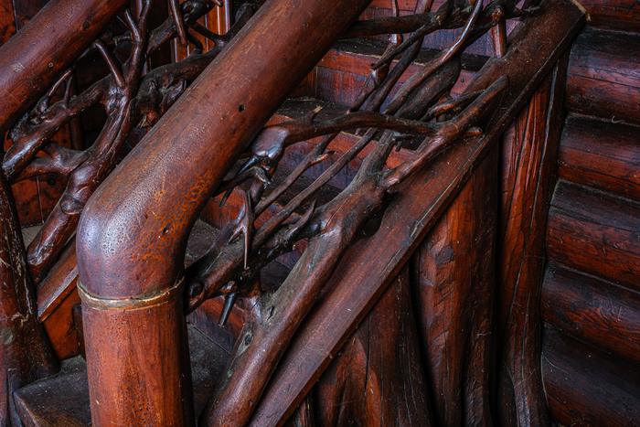 Close view of a stair railing made of mitered tree roots