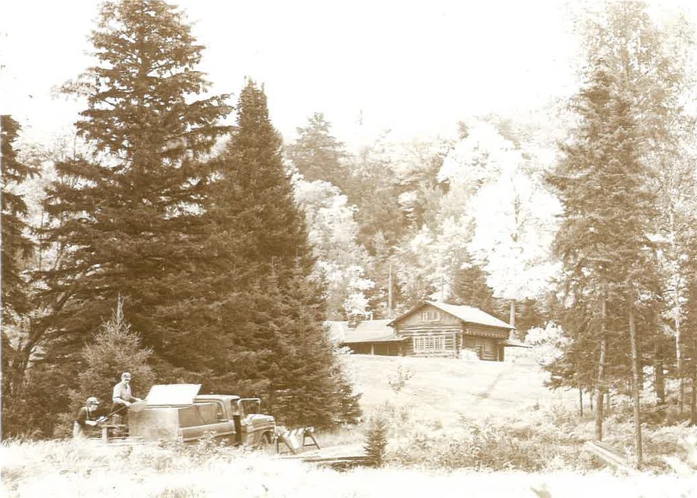 Sepia photograph of a tank truck in a clearing below the cabin, fall 1973